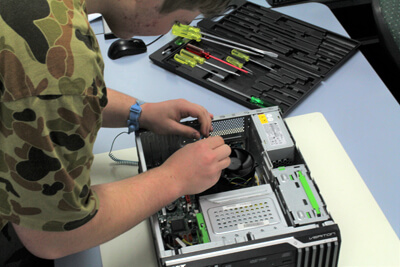 Student fixing a computer
